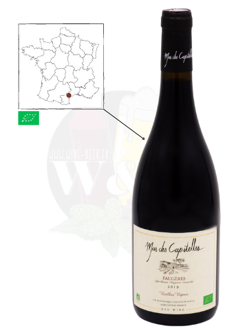 Bouteille d'AOC Faugères - Mas de Capitelles. C'est un vin rouge bio, à partir de vieilles vignes de 80 ans. Il possède des tannins denses, sur des notes de cerise et de cassis.